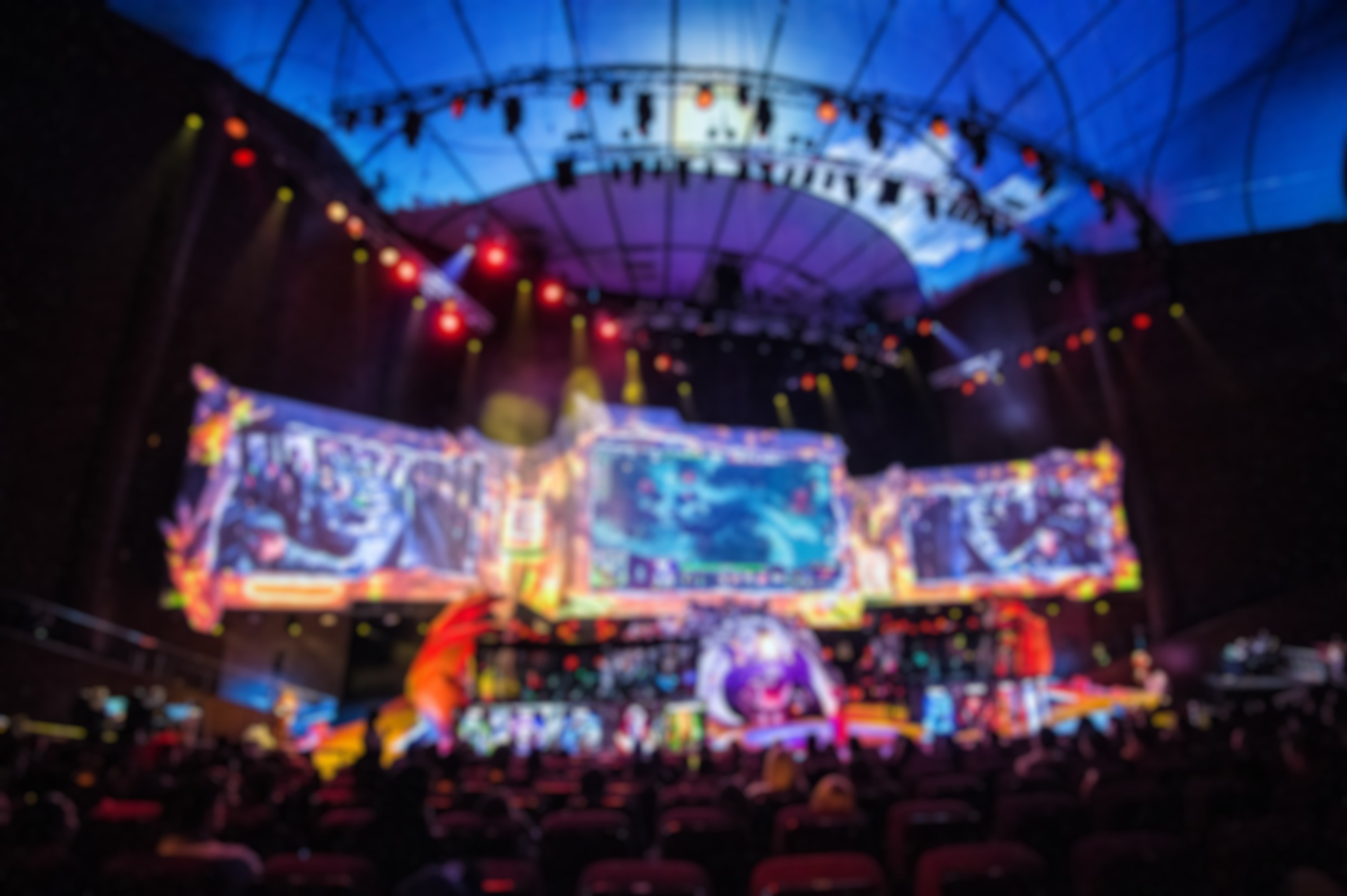 Esports event at big arena with a lot of lights and screens