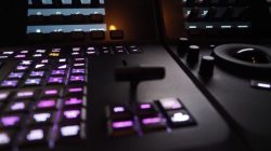 Edit video production control panel in studio. Editor editing and grade film in movie post room. Telecine control machine and person hand editing or adjusting color on digital video in post production.