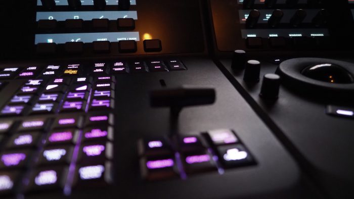 Edit video production control panel in studio. Editor editing and grade film in movie post room. Telecine control machine and person hand editing or adjusting color on digital video in post production.