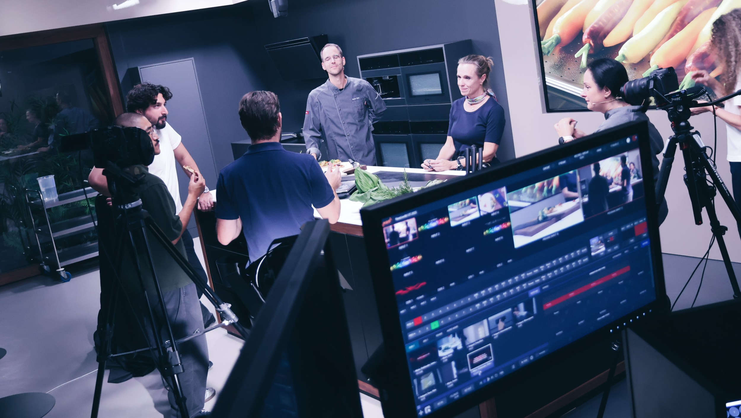 A full production crew surrounds the Miele kitchen set during a live cooking segment