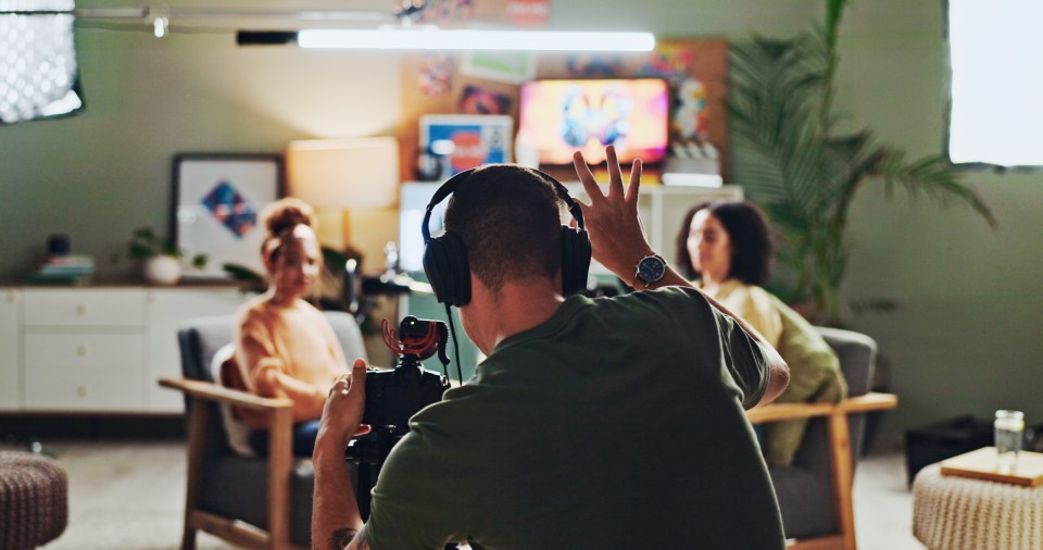 Interview, podcast and streaming with director in studio for videography or live broadcast on air. Camera, content creation and recording with people on production set for creative collaboration.